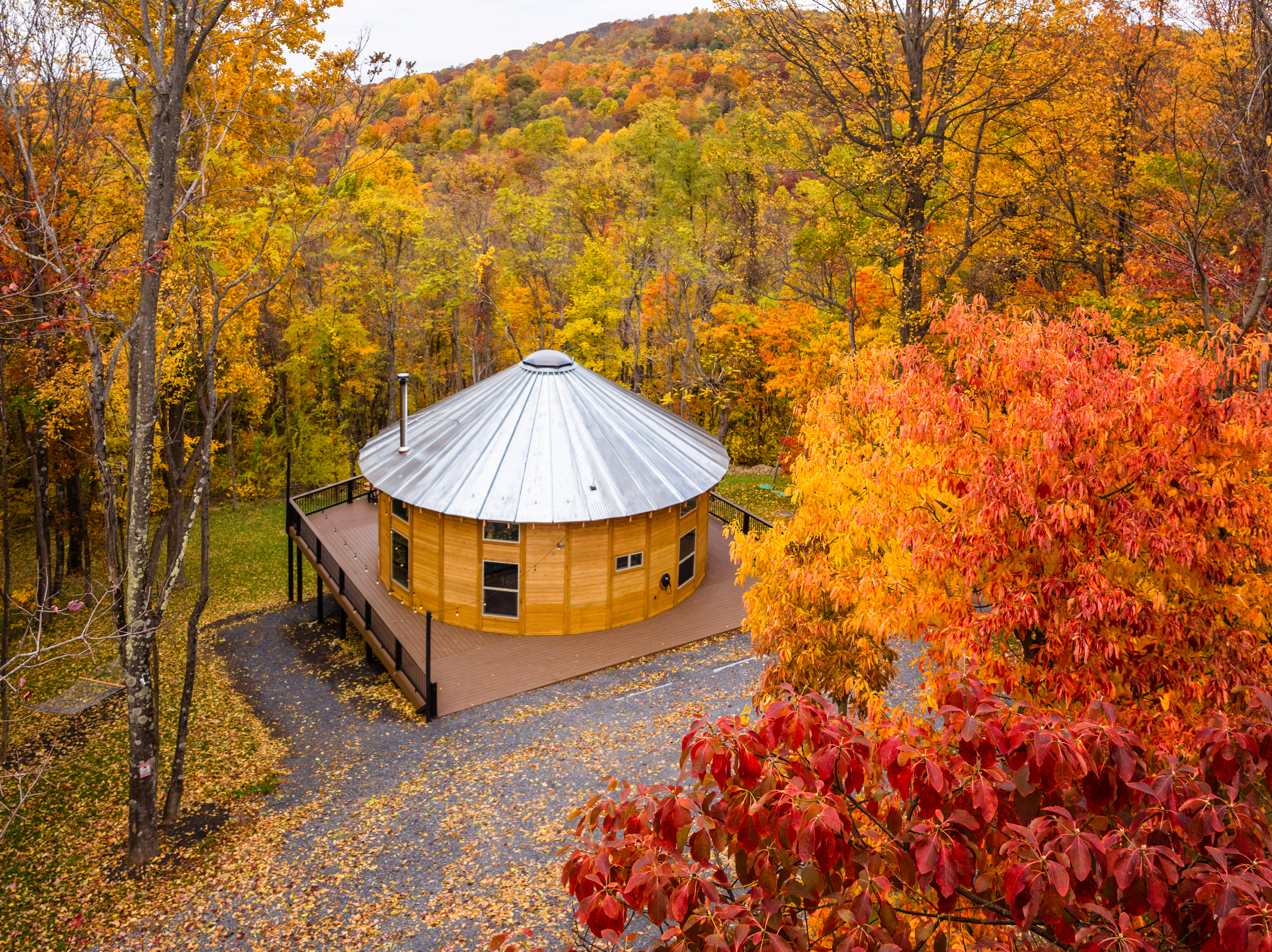 <span  class="uc_style_uc_tiles_grid_image_elementor_uc_items_attribute_title" style="color:#ffffff;">Shenandoah Yurt encircled by a tapestry of vibrant fall foliage and the gentle embrace of autumn</span>