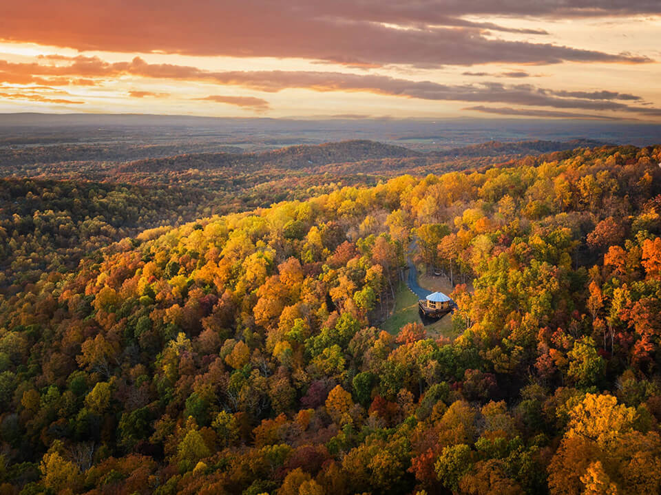 Yurt nestled in an autumn forest landscape