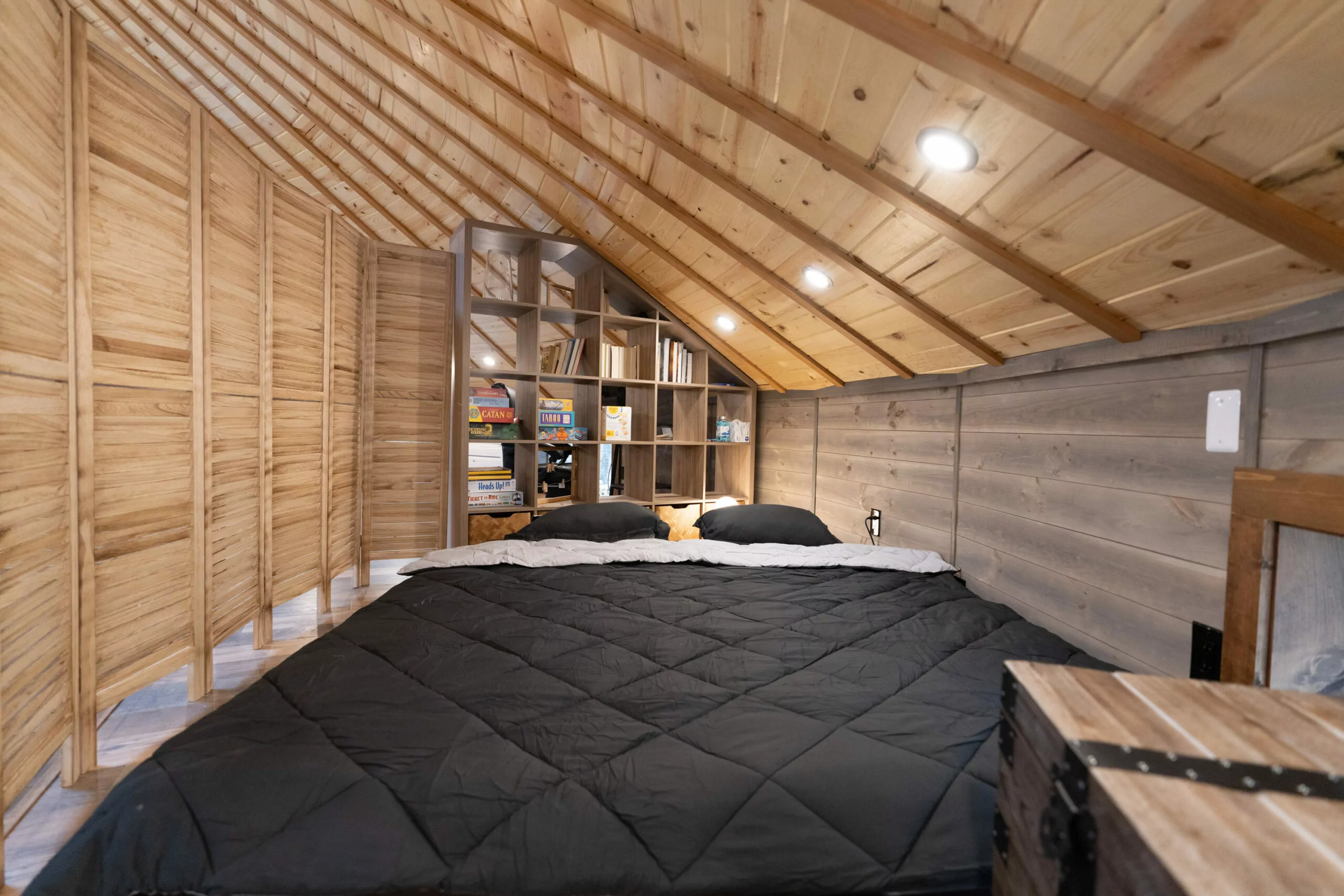 Floor sofa transformed into KING size bed with a privacy screen -- Shenandoah Yurt, Shenandoah Cabin