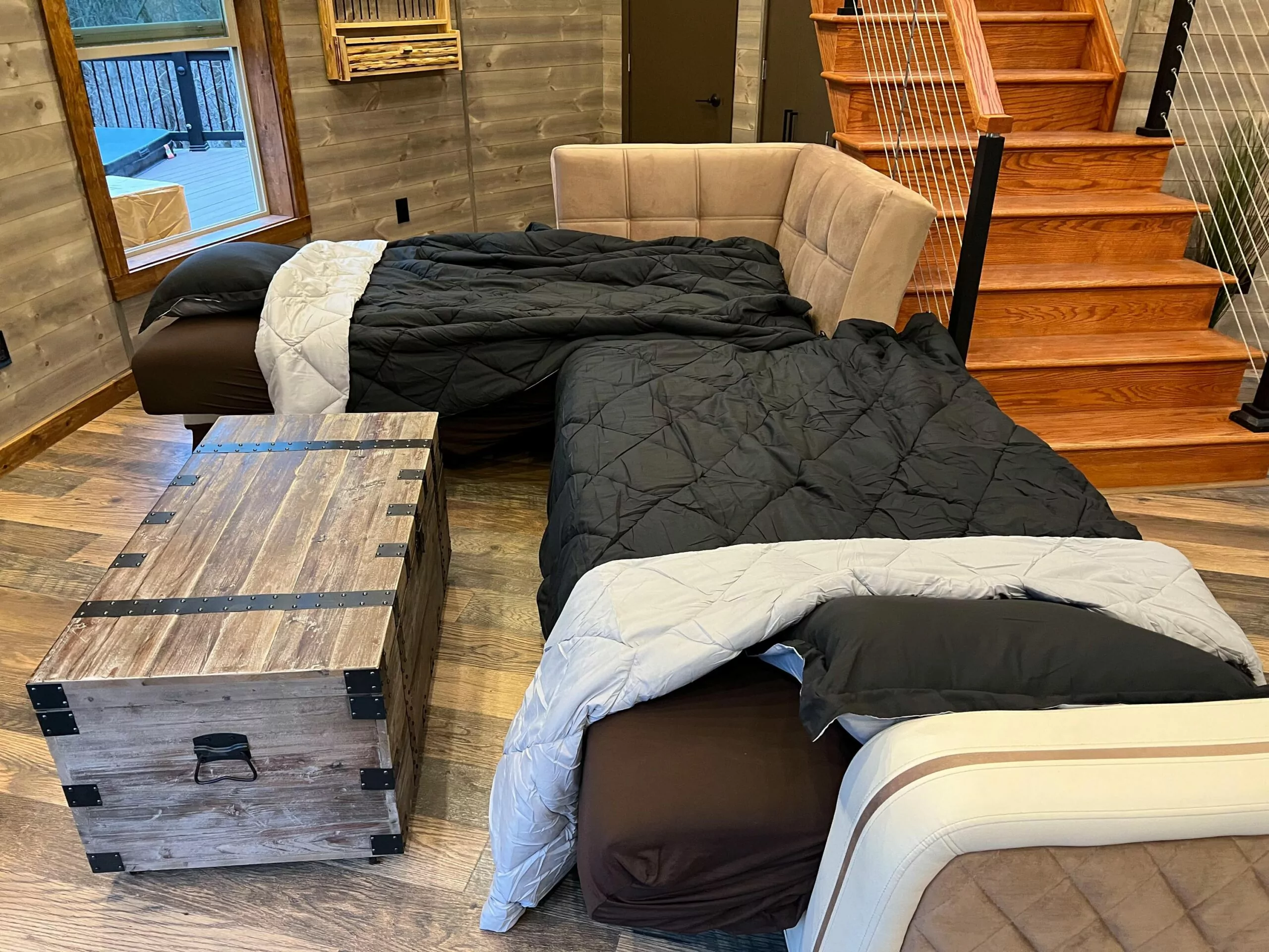 The living room sofa transforms into two half-separate beds -- Shenandoah Yurt, Shenandoah Cabin